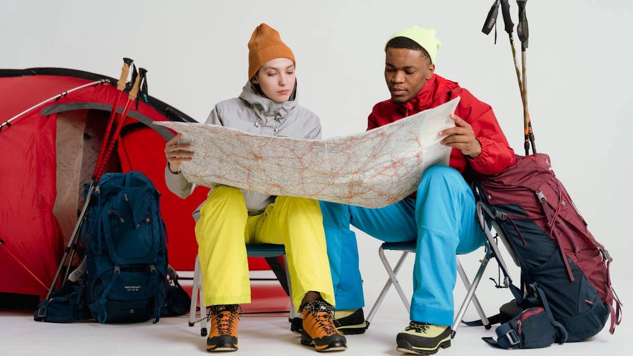 Two hikers reading map