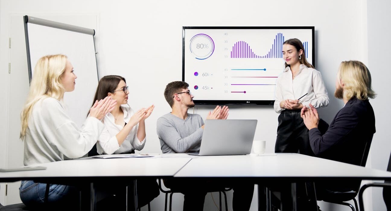 Small business team reviewing AI dashboard and governance metrics during an office meeting