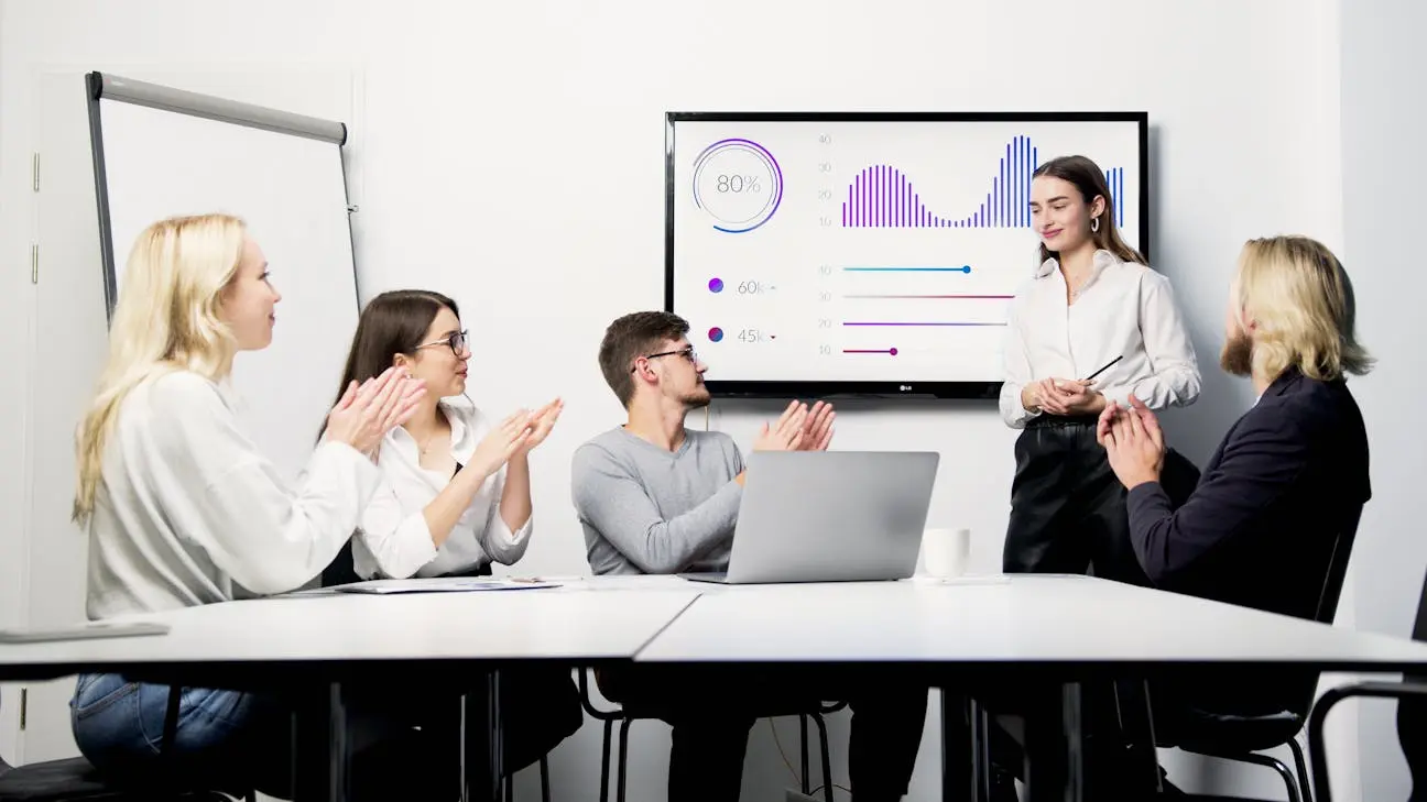 Small business team reviewing AI dashboard and governance metrics during an office meeting