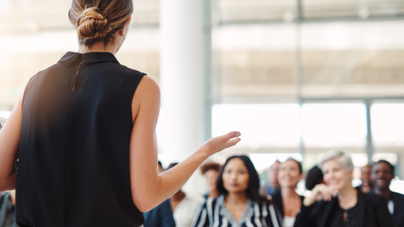 Woman delivering paid speaking session to audience