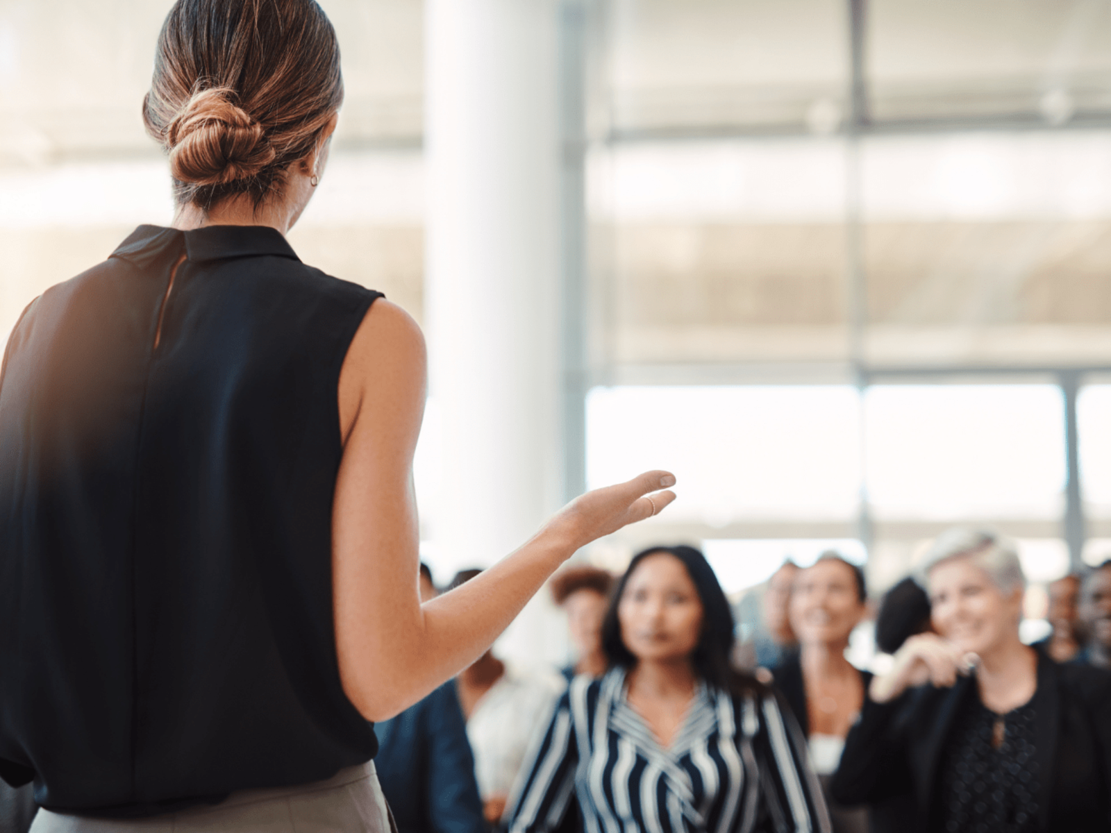 Woman delivering paid speaking session to audience